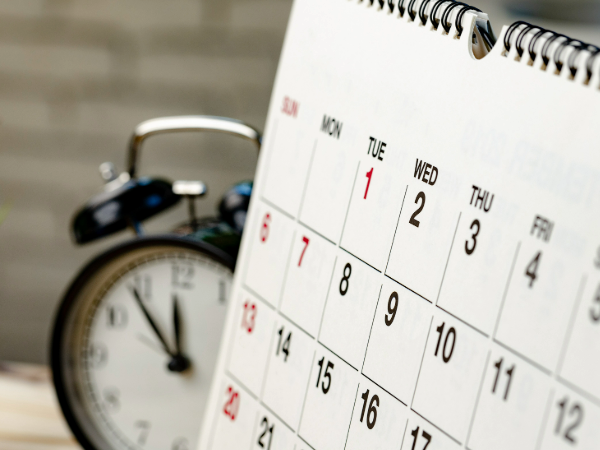 desk calendar with clock in background